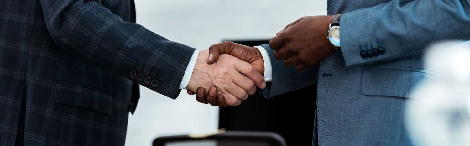 african american businessman shaking hands with partner