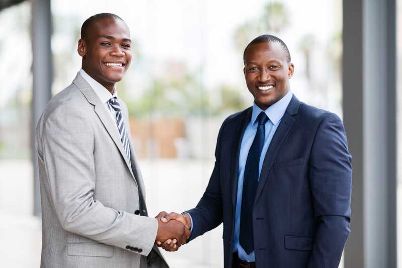Africans smiling and shaking hands